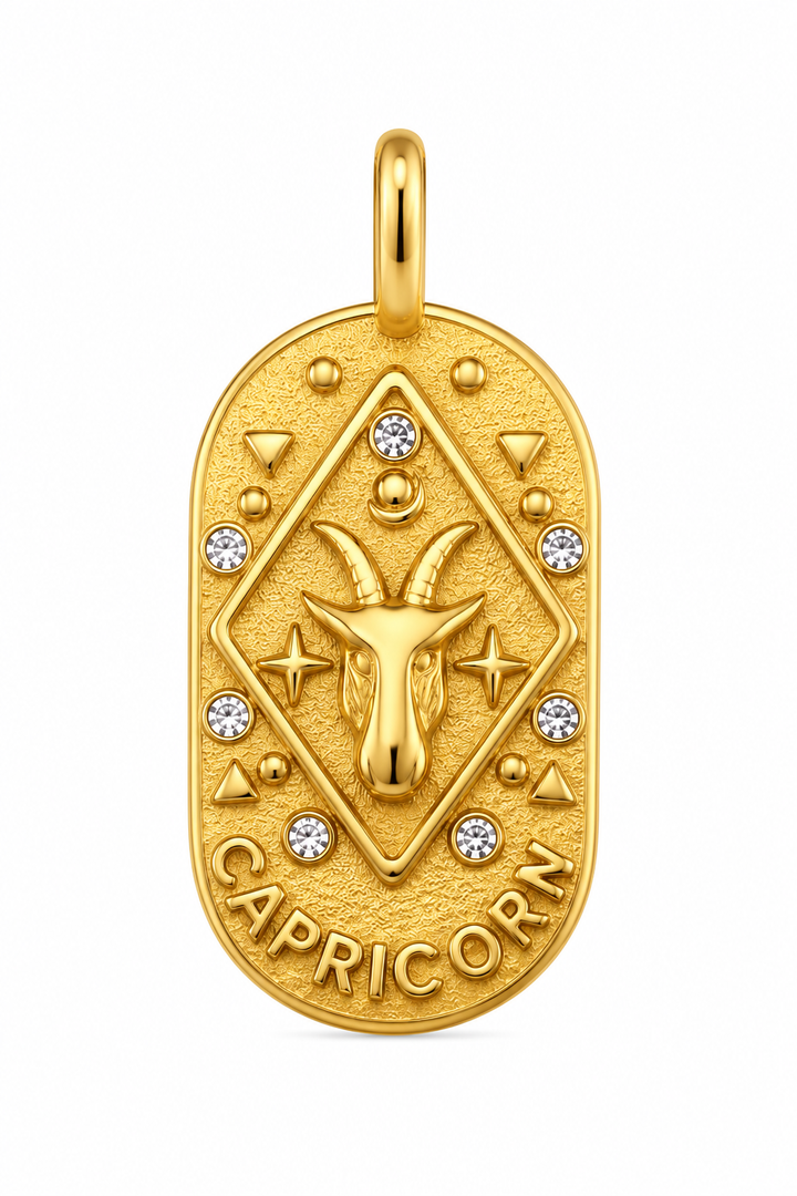 a gold pendant with a goat head and diamonds