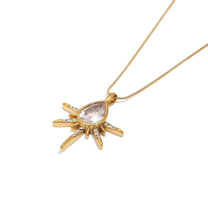 a gold necklace with a diamond pendant