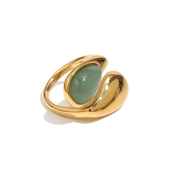 a gold ring with a green stone