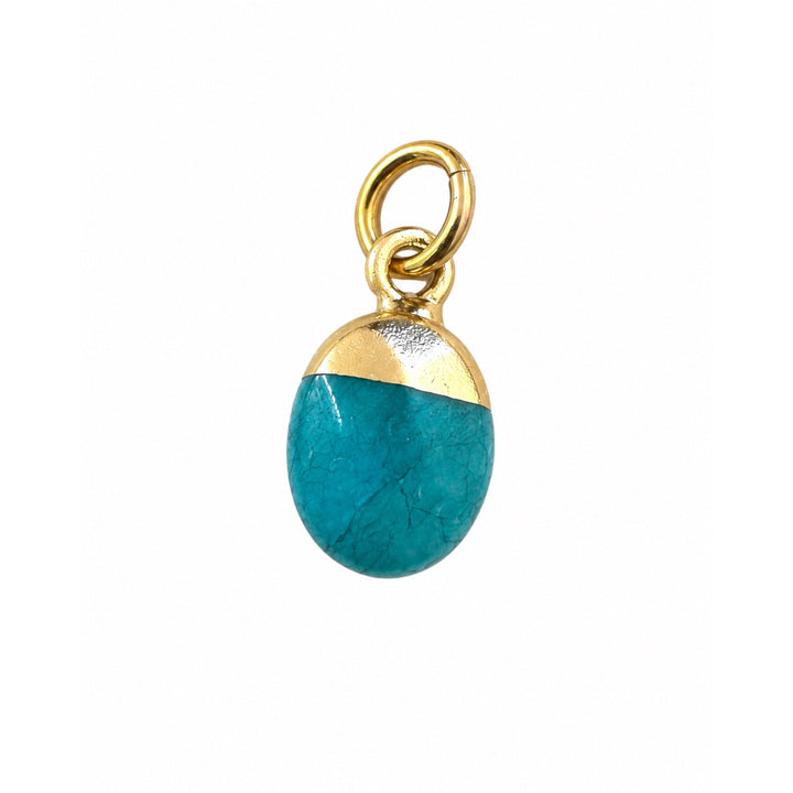 a close up of a blue and gold pendant
