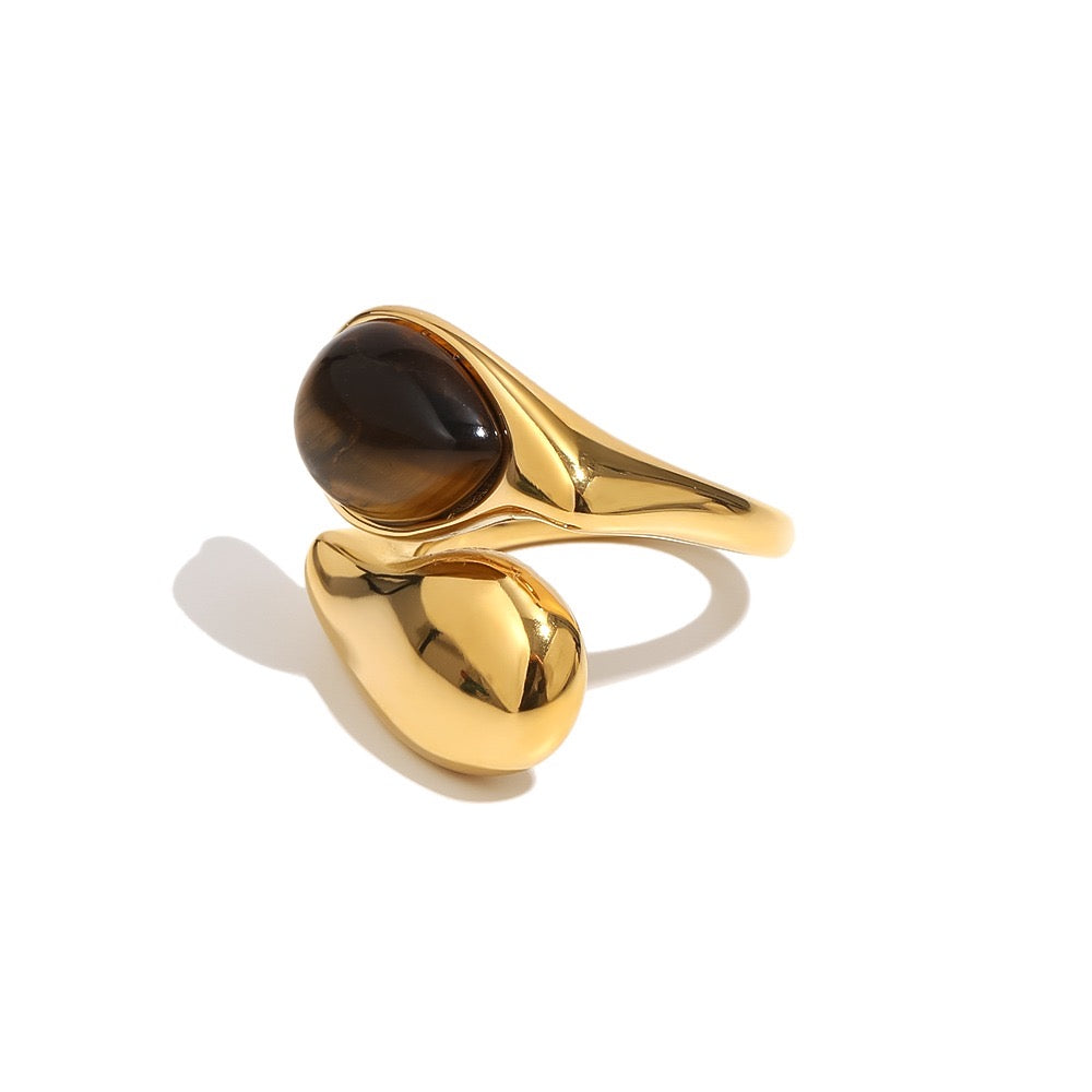 a gold ring with a brown stone