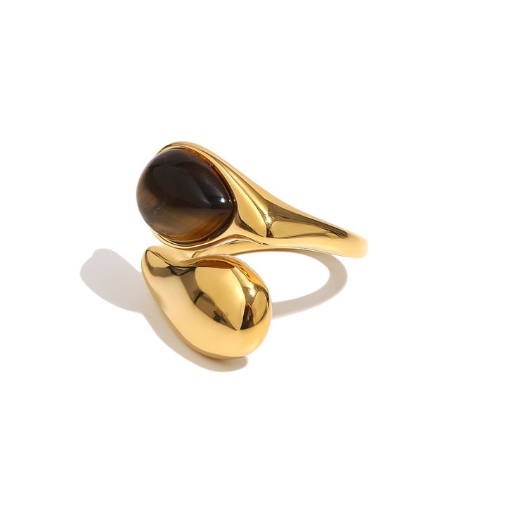 a gold ring with a brown stone