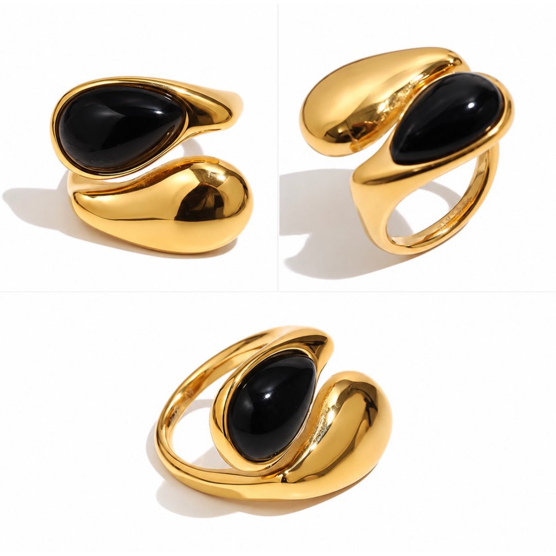 a gold ring with black stone