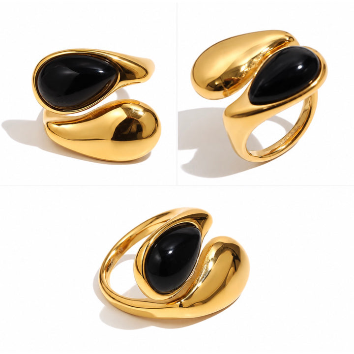 a gold ring with black stone