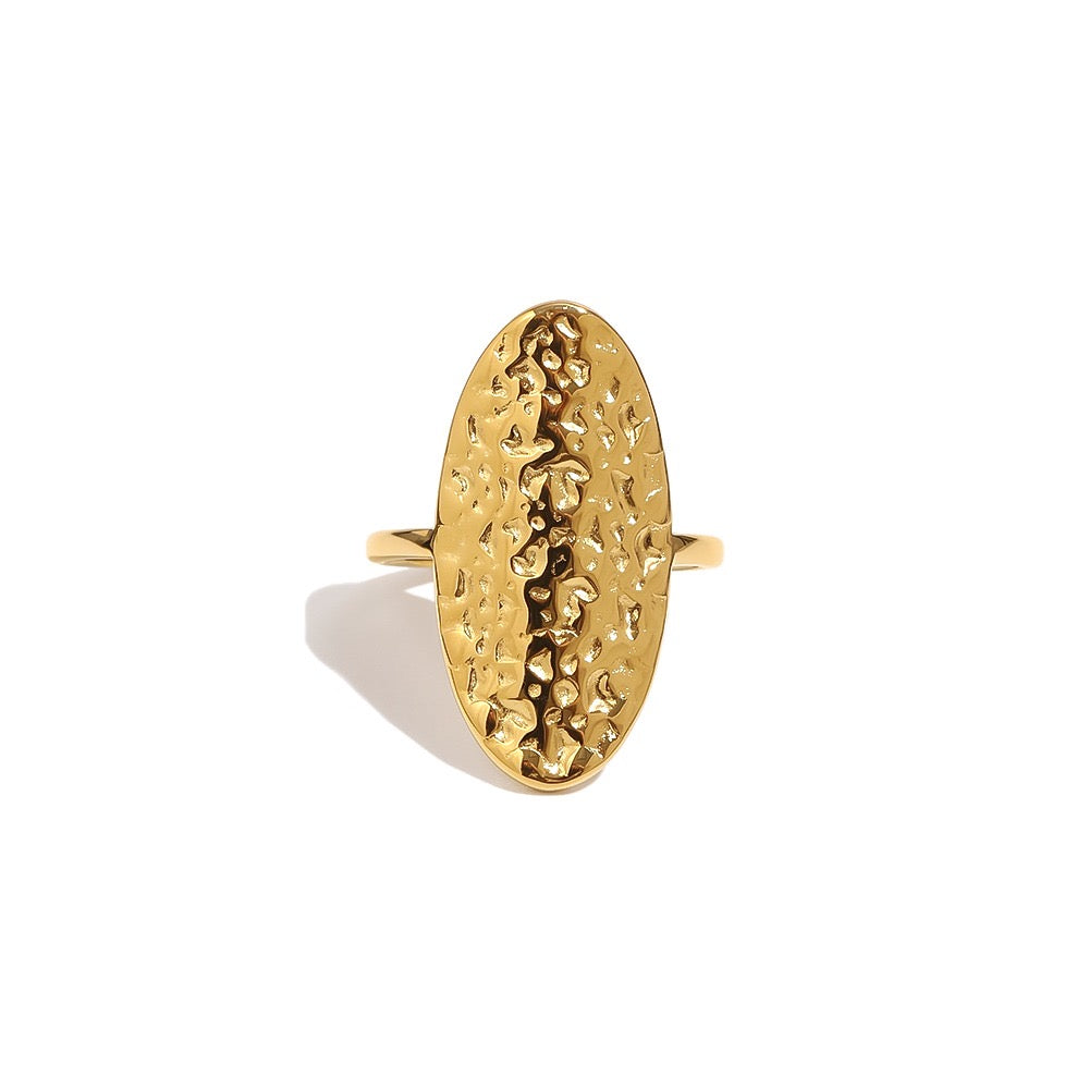 a gold ring with a textured oval shape