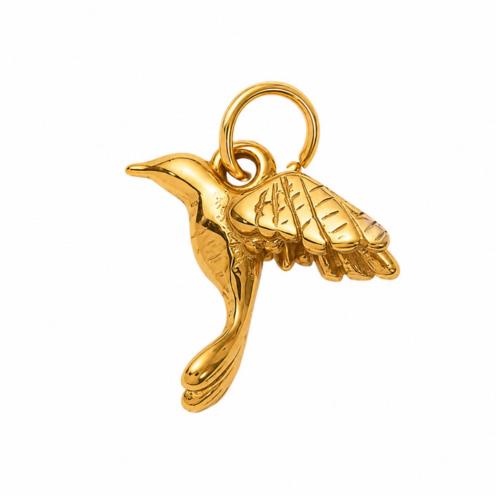a gold bird pendant on a white background