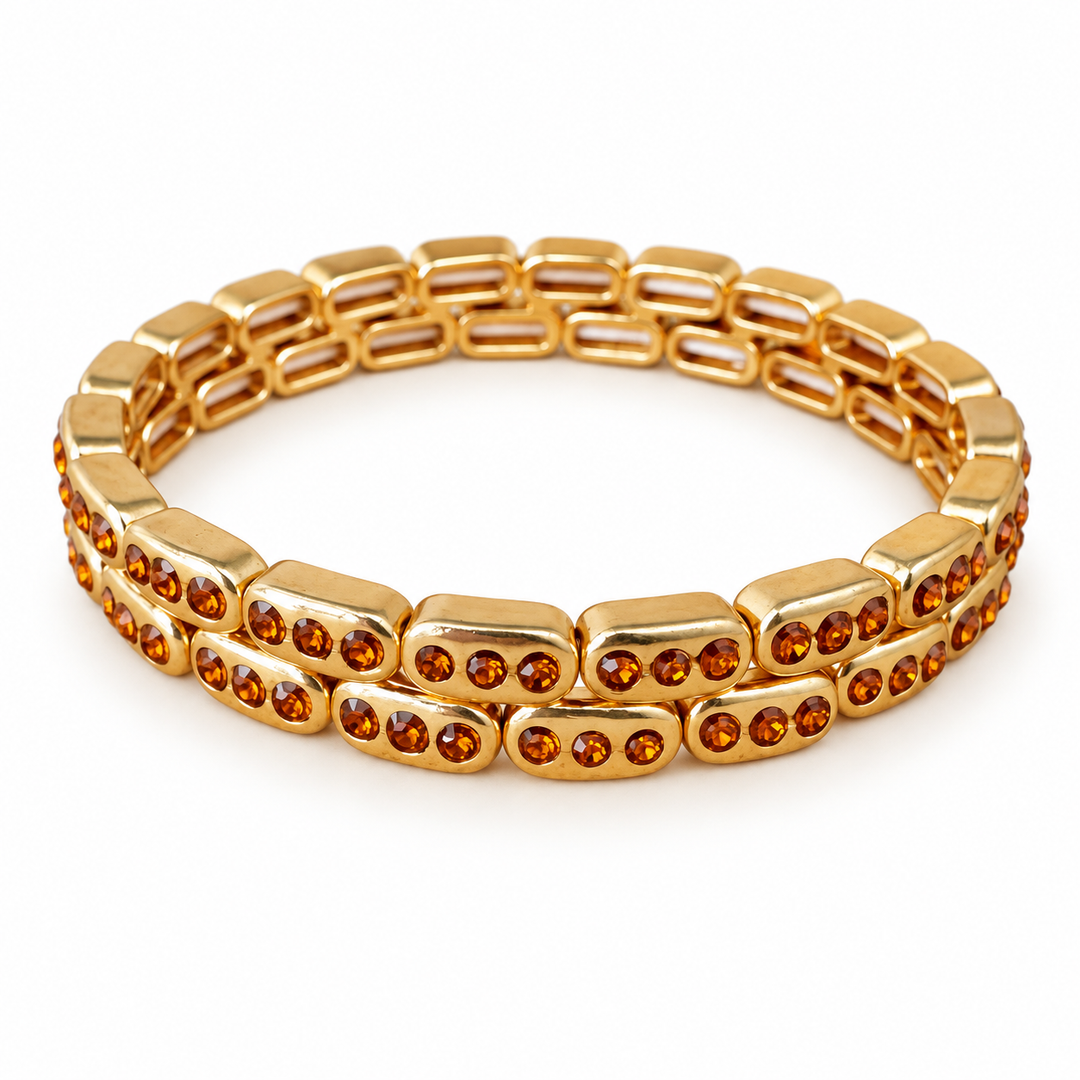 a gold bracelet with orange stones