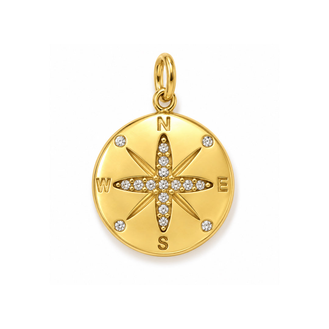 a gold medallion with diamonds and a compass