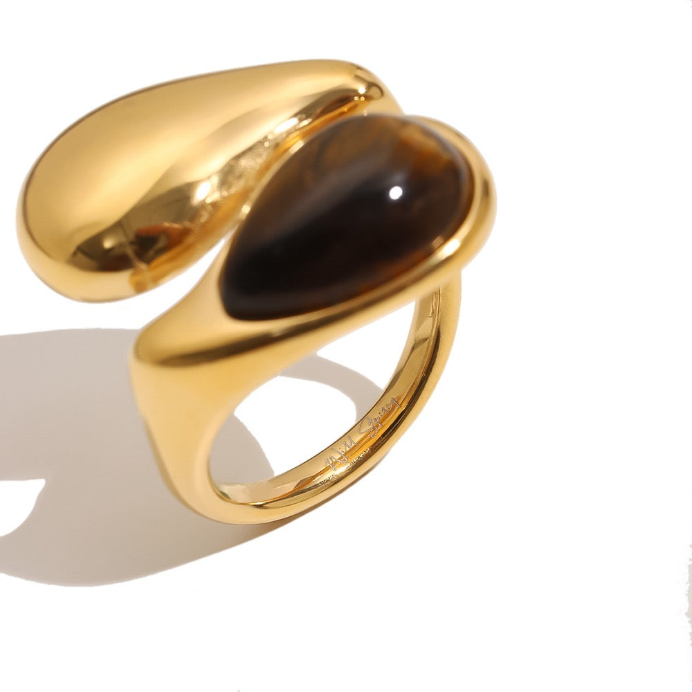a gold ring with a black stone