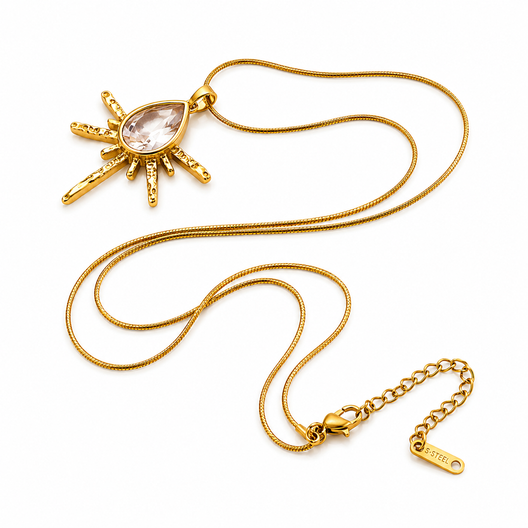 a gold necklace with a stone pendant