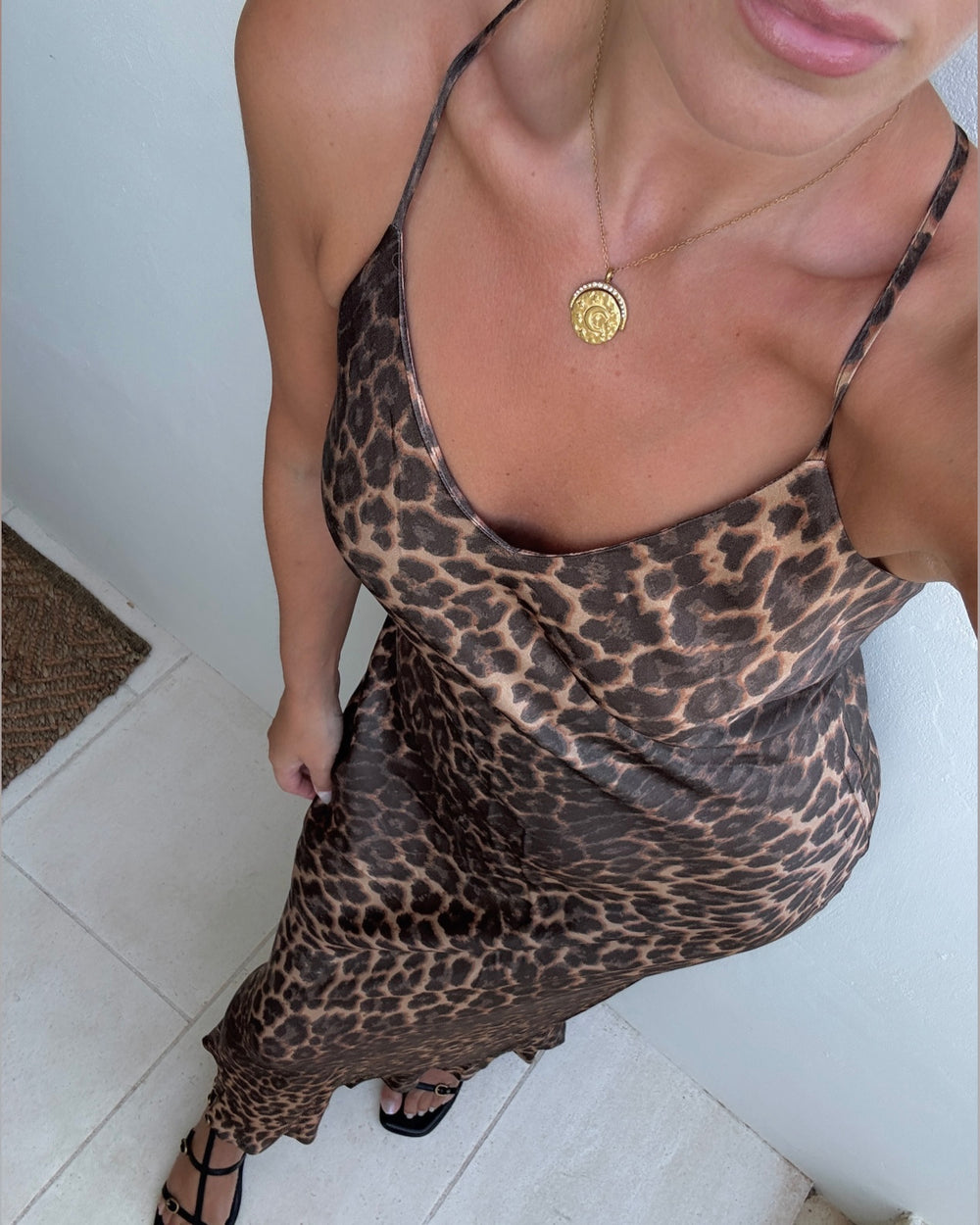 a woman wearing a leopard print dress