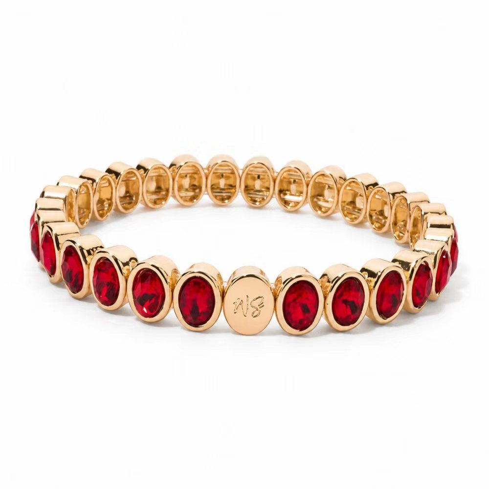 a gold bracelet with red stones