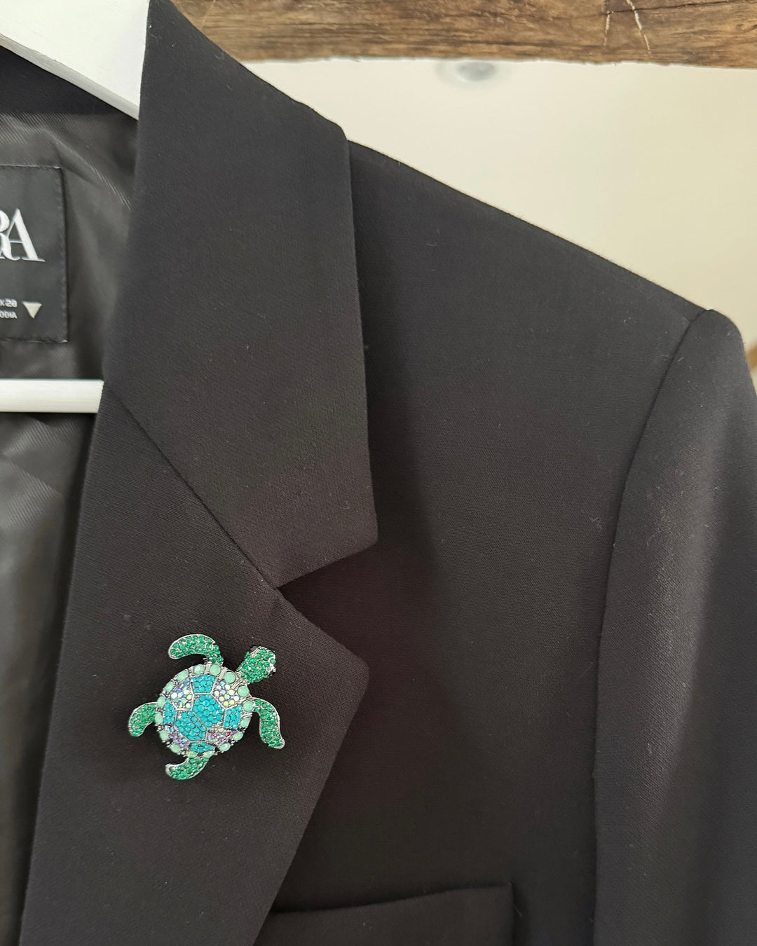 a turtle pin on a coat