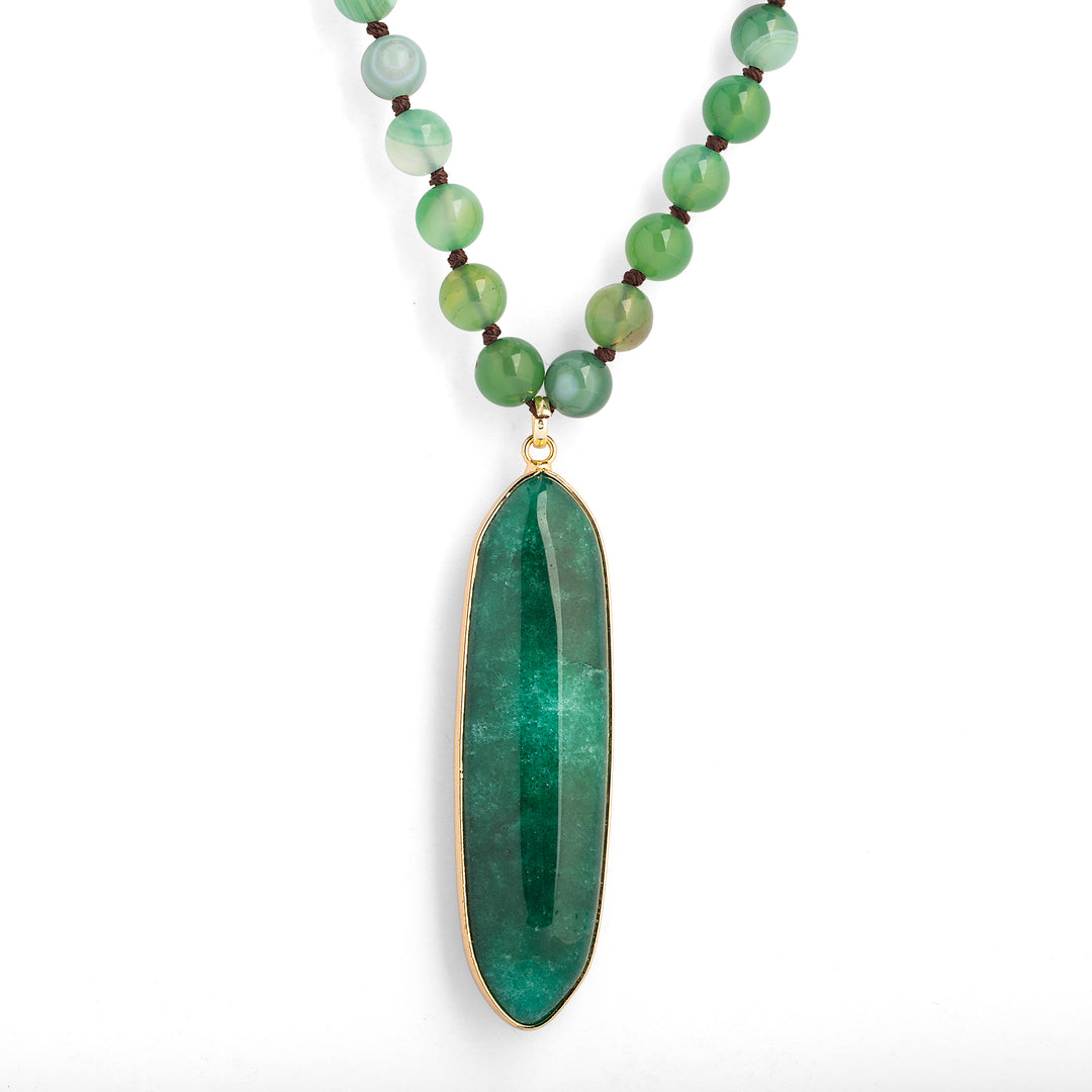 a necklace with a green stone pendant